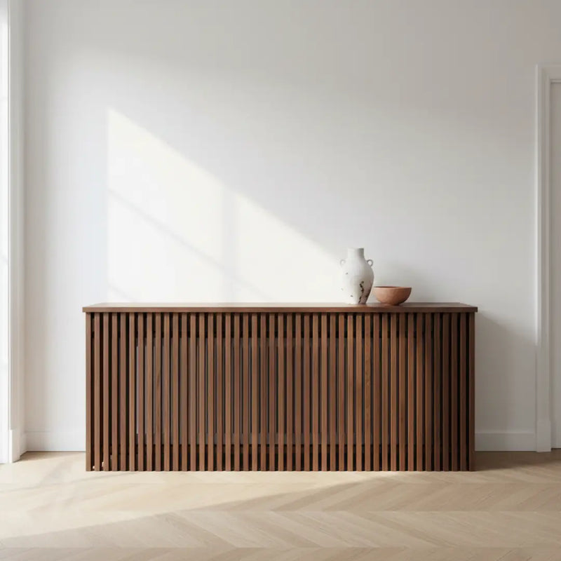 Solid walnut radiator cover with vertical slats and a hand-oiled finish in a modern interior.