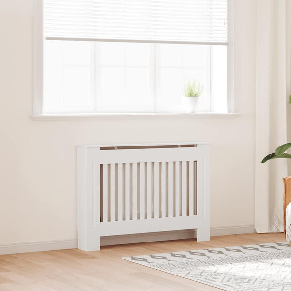 White radiator cover with vertical slats beneath a bright window in a modern room.