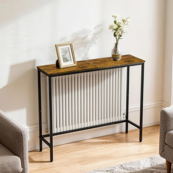 Black-framed radiator cover with a wooden top and vertical slatted front panel in a bright living room.