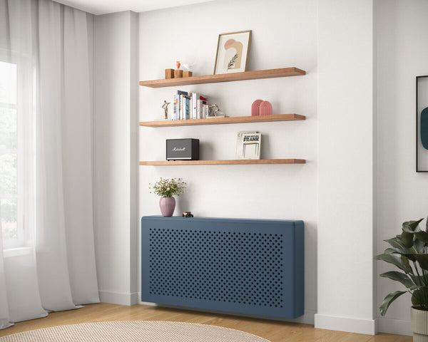Blue radiator cover with a diamond-patterned front panel in a modern living room.