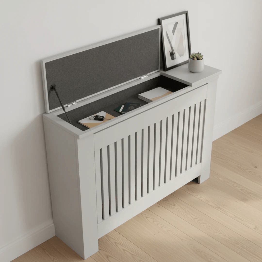 White storage bench with a lift-up lid against a white wall.